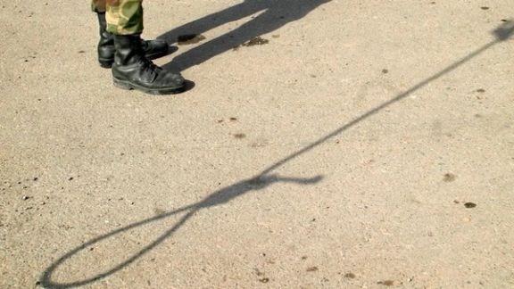 Shadows of an Iranian policeman and a noose are seen on the ground before the execution of Iranian killer Bijeh in Pakdasht, south of Tehran