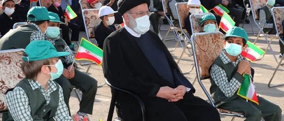 Former Iranian President Ebrahim Raisi among a group of schoolboys in Tehran