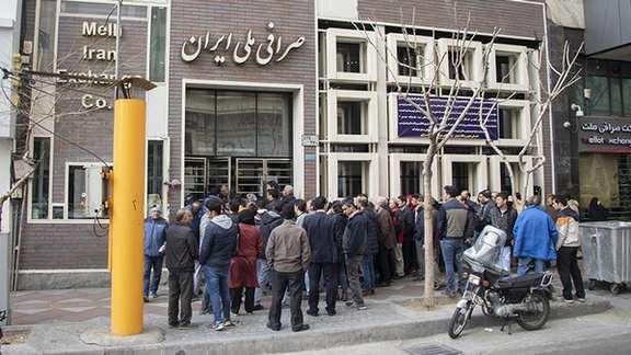 People waiting outside a bank exchange office to buy dollars in December 2021