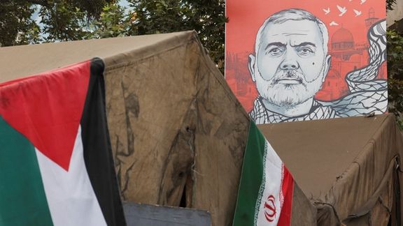A banner with a picture of late Hamas leader Ismail Haniyeh is displayed next to the Iran and Palestinian flags in a street in Tehran, Iran, August 12, 2024.