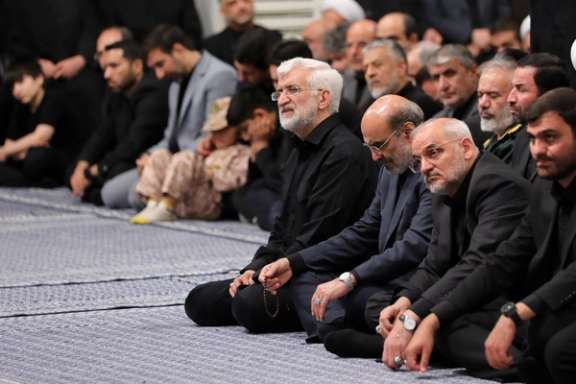 Saeed Jalili (left), a former chief negotiator and current member of Iran's Supreme National Security Council, listens to slain Supreme Leader Ali Khamenei in this file photo from 2025