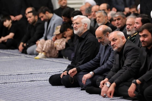 Saeed Jalili (left), a former chief negotiator and current member of Iran's Supreme National Security Council, listens to slain Supreme Leader Ali Khamenei in this file photo from 2025