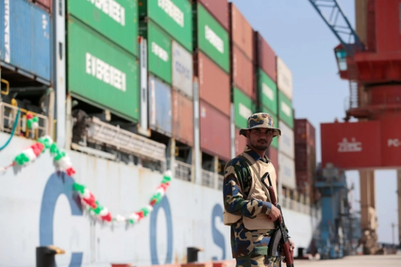 A soldier stands guard beside the Cosco Wellington, the first container ship to depart after the inauguration of the China Pakistan Economic Corridor port in Gwadar, Pakistan November 13, 2016.