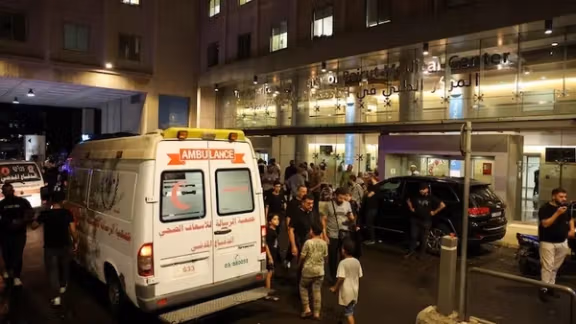 People walk near an ambulance outside American University of Beirut Medical Center (AUBMC) as people, including Hezbollah fighters and medics, were wounded and killed when the pagers they use to communicate exploded across Lebanon, according to a security source, in Beirut, Lebanon September 17, 2024.