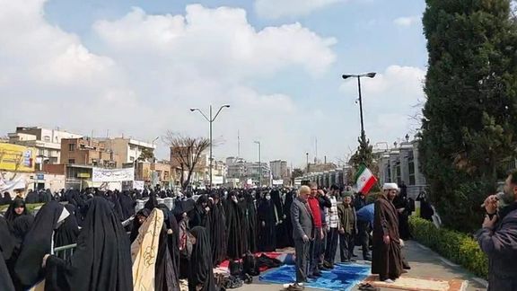 Hijab protesters pray outside the Parliament during rally