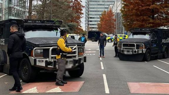 Armored police vehicles are seen outside the headquarters of Iran International on November 19, 2022
