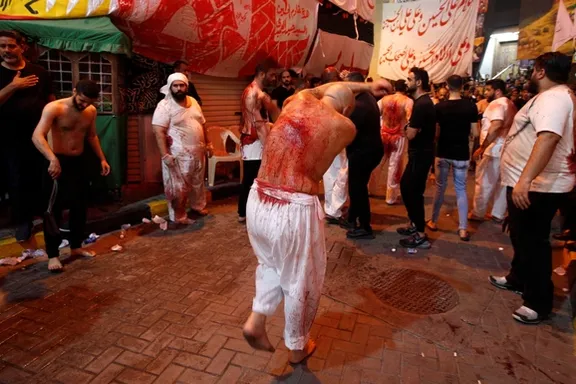 Bahraini Shiite Muslims flagellate themselves as they attend the mourning procession to mark Ashura, in Manama, Bahrain, August 8, 2022.