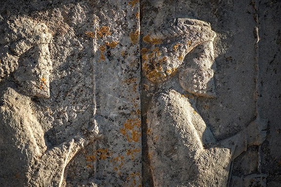 Achaemenid soldiers surrounded with spreading lichens in Persepolis, a World Heritage in southern Iran