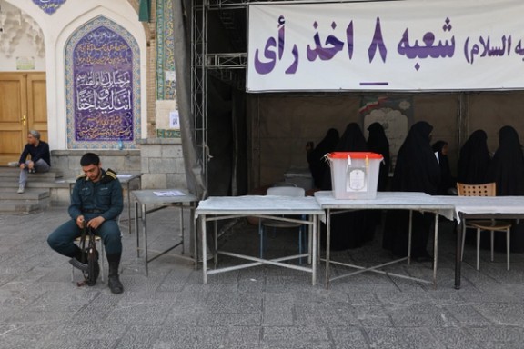 A security officer sits at a polling centre for the run-off presidential election between Masoud Pezeshkian and Saeed Jalili in Tehran, Iran, July 5, 2024.