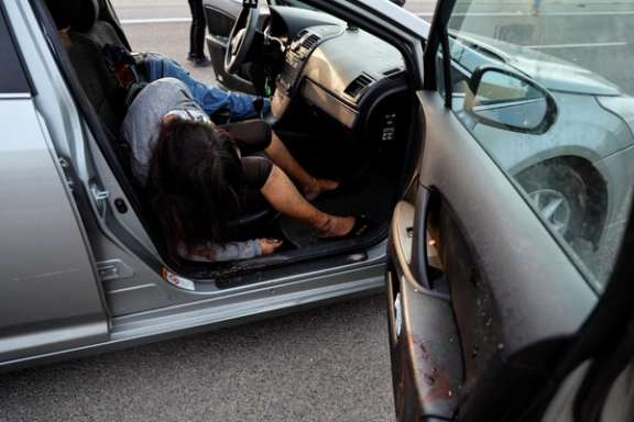 A man and woman lie dead in their car, in the Sderot area, southern Israel October 7, 2023.