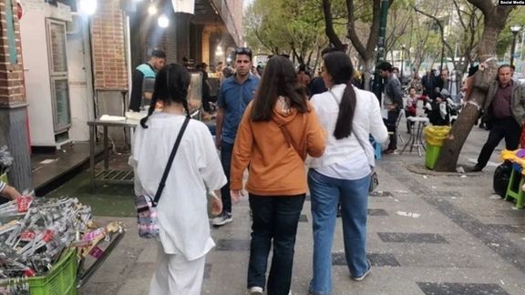 Young women without hijab in Tehran streets. Undated