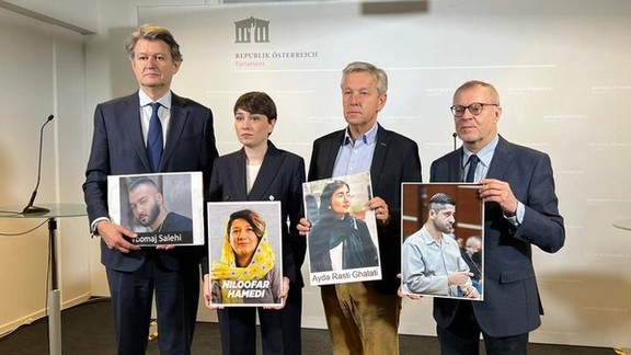 Members of the Austrian parliament holding photos of Iranian protesters in danger of execution