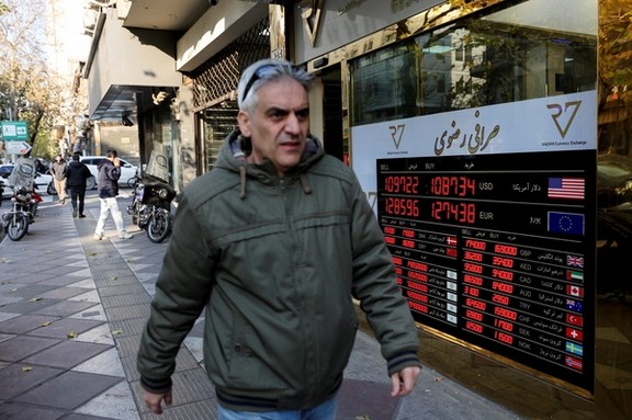 A man walks past a sign at a currency exchange bureau as the value of the Iranian rial drops, in Tehran, Iran, December 20, 2025.