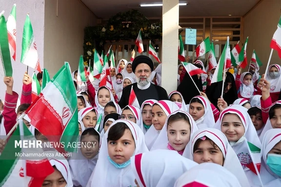 Iranian President Ebrahim Raisi among a group of schoolgirls in Tehran