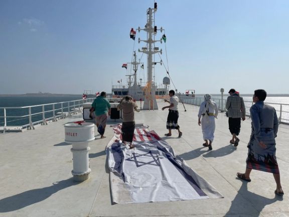 People tour the deck of the Galaxy Leader commercial ship, seized by Yemen's Houthis last month, off the coast of al-Salif, Yemen December 5, 2023.