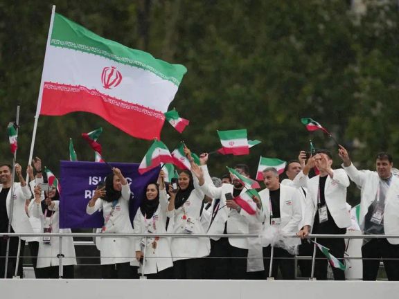 The Iranian team waves their flags in their official attire during the parade at the 2024 Paris Olympics on July 26, 2024.
