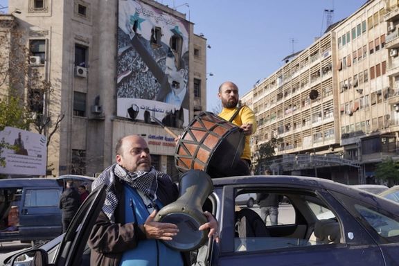 People celebrate along a street in Aleppo, Syria December 8, 2024.