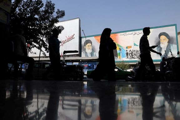 People walk past a mural depicting the late leader of the Islamic Republic Ruhollah Khomeini and Supreme Leader Ali Khamenei on a building in a street in Tehran, Iran, October 7, 2024.