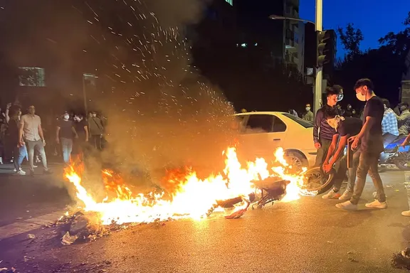 A police motorcycle burns during popular protests in Iran, September 19, 2022.
