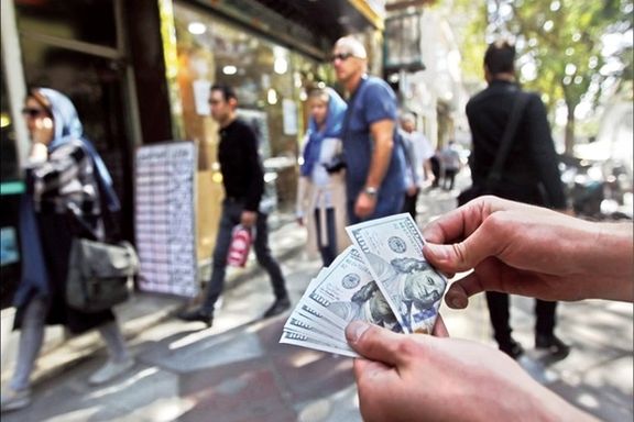 A street money changer in Tehran outside an official currency exchange business. Undated