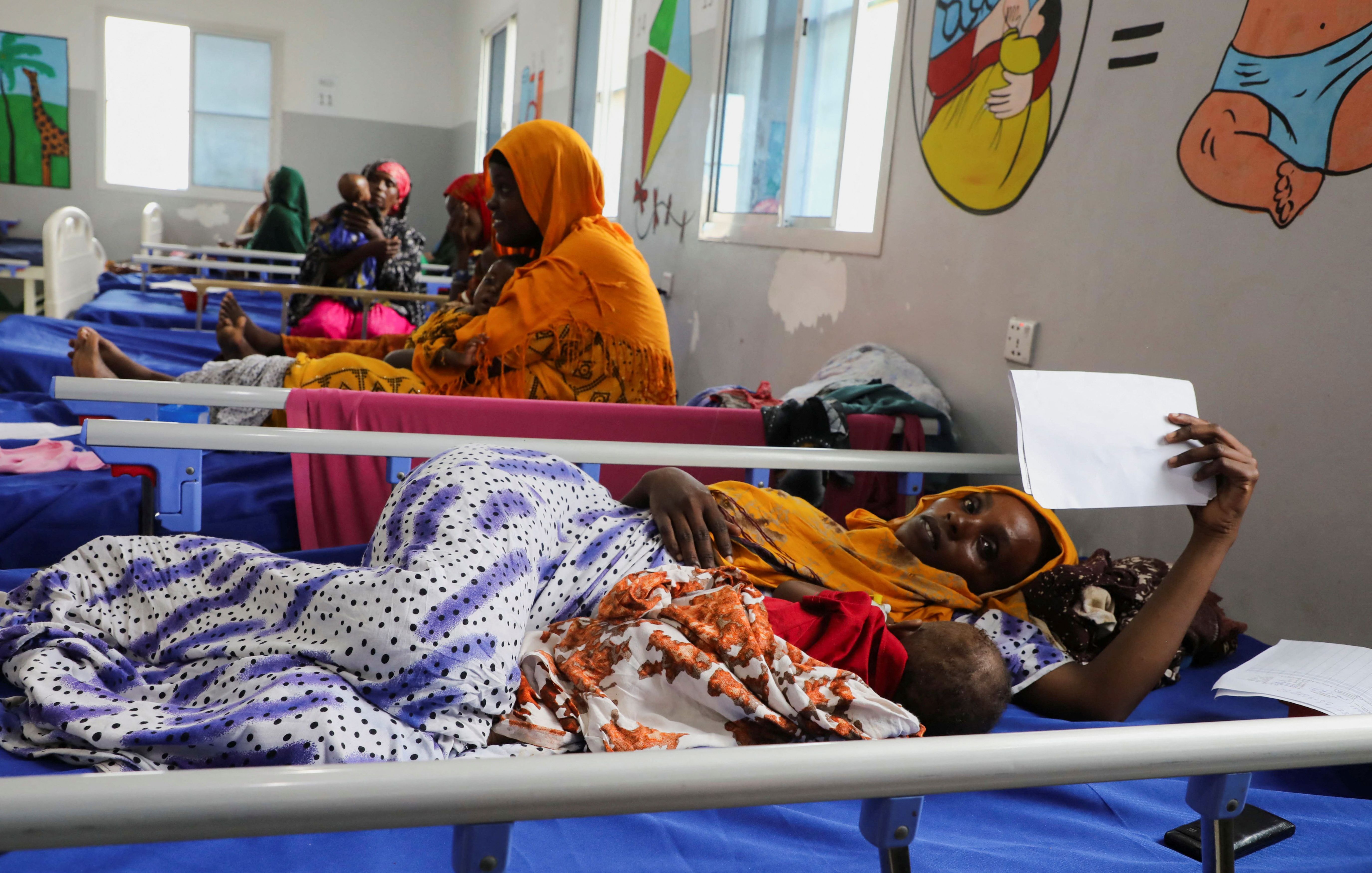 Internally displaced Somali women attend to their malnourished children at the pediatric ward within the Daynile hospital in Mogadishu, Somalia, on April 20, 2026. 