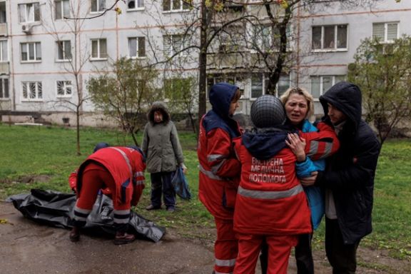 The body of an old man being retrieved after Russian shelling in Kharkiv as his daughter sobs. April 18, 2022