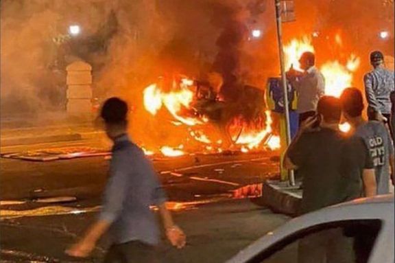 Protesters in the religious city of Mashhad setting fire to a police car on Nov. 16, 2022