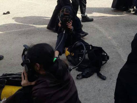 Schoolgirls breathing through oxygen masks after a chemical gas attack on their school