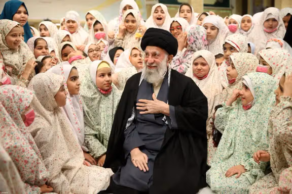 Iran’s Supreme Leader Ali Khamenei among a group of schoolgirls