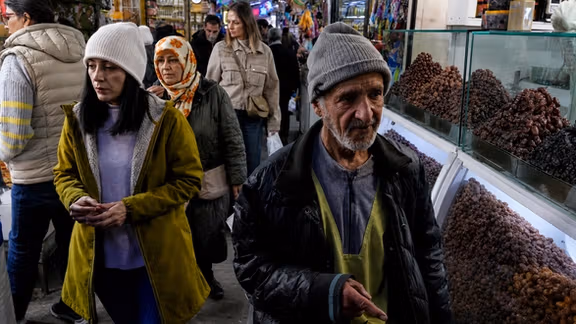 File photo of people walking through a traditional market in Iran.