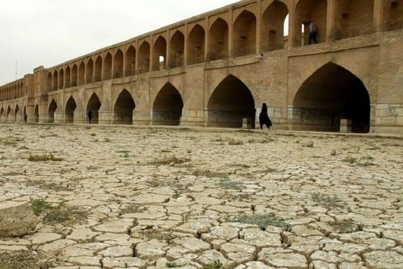 The dry bed of Zayandeh Rud in Isfahan and the city's historical Khajoo Bridge