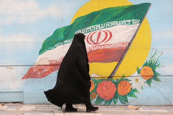 A woman walks after the morality police shut down in a street in Tehran, Iran December 6, 2022.
