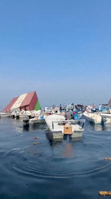 Containers float in the water after a vessel sank near the Strait of Hormuz, in this still image obtained from a social media video released Oct. 14.
