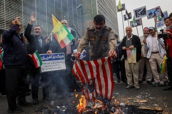 An Iranian man burns an American flag during the 44th anniversary of the U.S. expulsion from Iran, in Tehran, Iran November 4, 2023.