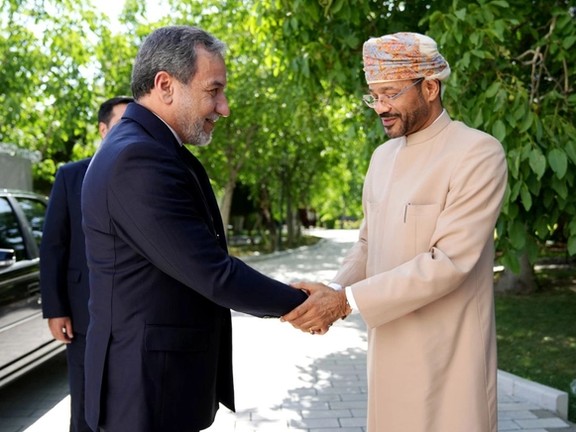 Iran's Foreign Minister Abbas Araghchi (left) and his Omani counterpart Badr al-Busaidi