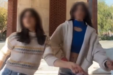 A screenshot from the video showing the two girls dancing at the "Monument to the Unknown Martyrs of the Sacred Defence" in Tehran.