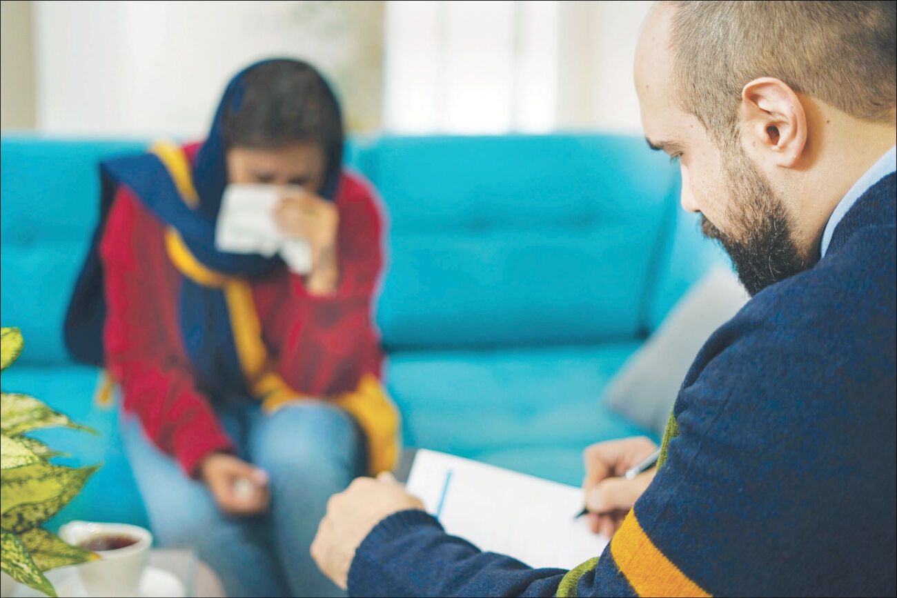 A therapist meets with a patient in Iran, where rising treatment costs are making mental healthcare less affordable.