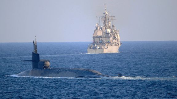 A US submarine and naval vessel in Persian Gulf waters
