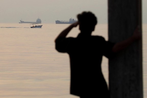 A man looks out at ships off the coast of Bandar Abbas, near the Strait of Hormuz, October 24, 2026