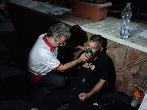Emergency responders evacuate patients following a fire at Qaem Hospital in Rasht, northern Iran, on June 18, 2024