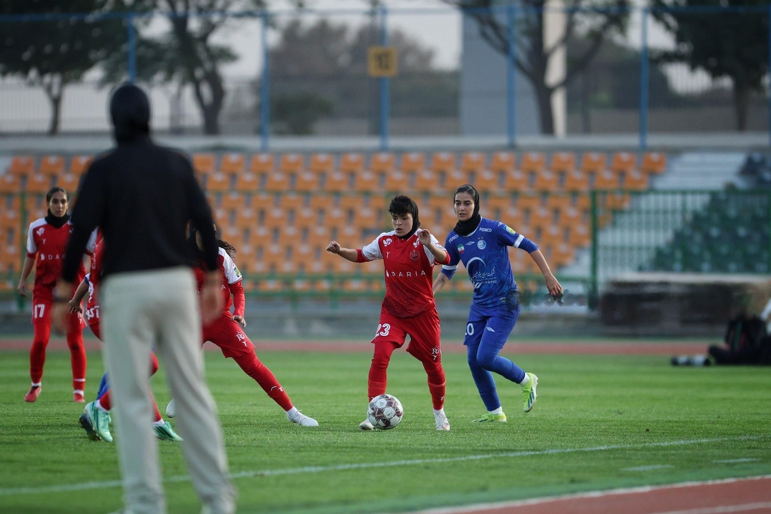Persepolis (red) and Esteghlal (blue) players compete during their first-ever women's soccer derby west of Tehran, October 28, 2026.
