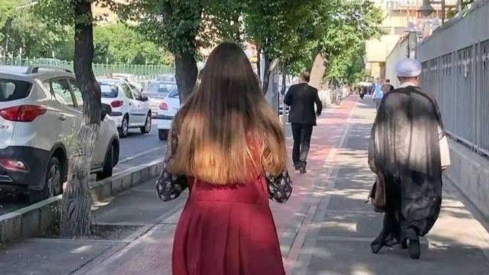 An Iranian woman defying mandatory hijab in public  