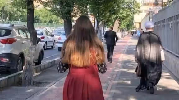 An Iranian woman defying mandatory hijab in public