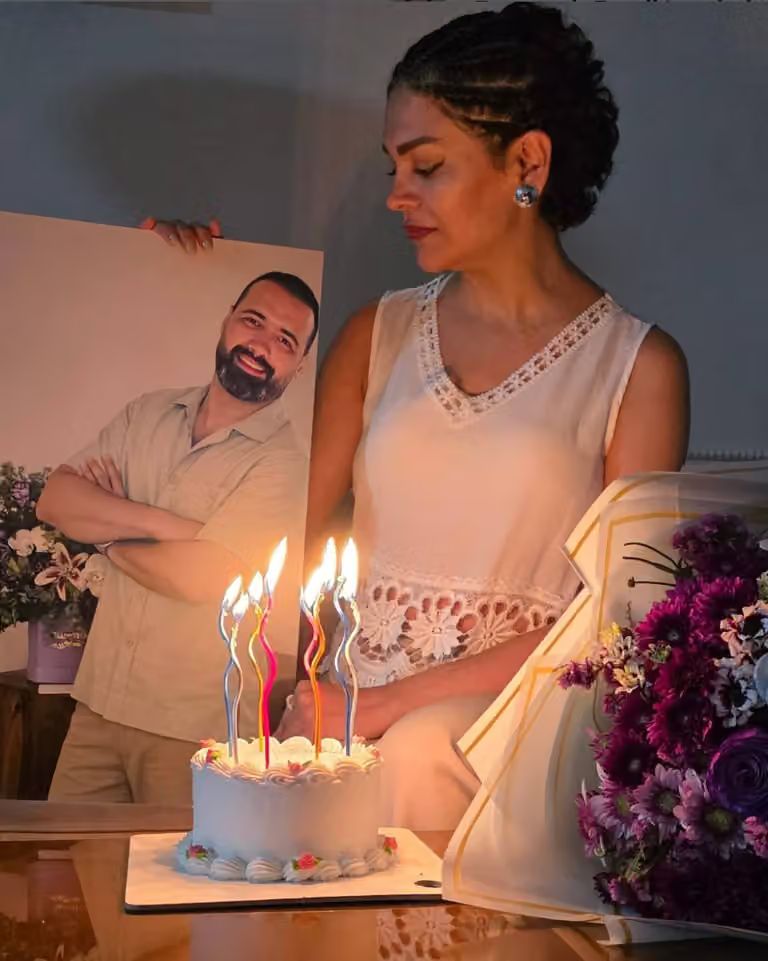 Elham Sadeghi marks her wedding anniversary beside a photograph of her husband, Mohsen Jabbarzadeh, after his death during Iran’s January protests.