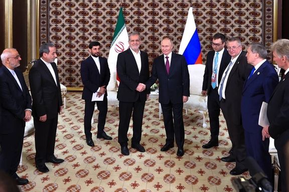 Russian President Vladimir Putin and Iranian President Masoud Pezeshkian shake hands during their first official meeting in Ashgabat, Turkmenistan, on Friday, October 11, 2024.