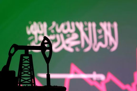 Saudi Arabian flag with stock graph and an oil pump jack miniature model are seen in this illustration taken October 9, 2023.