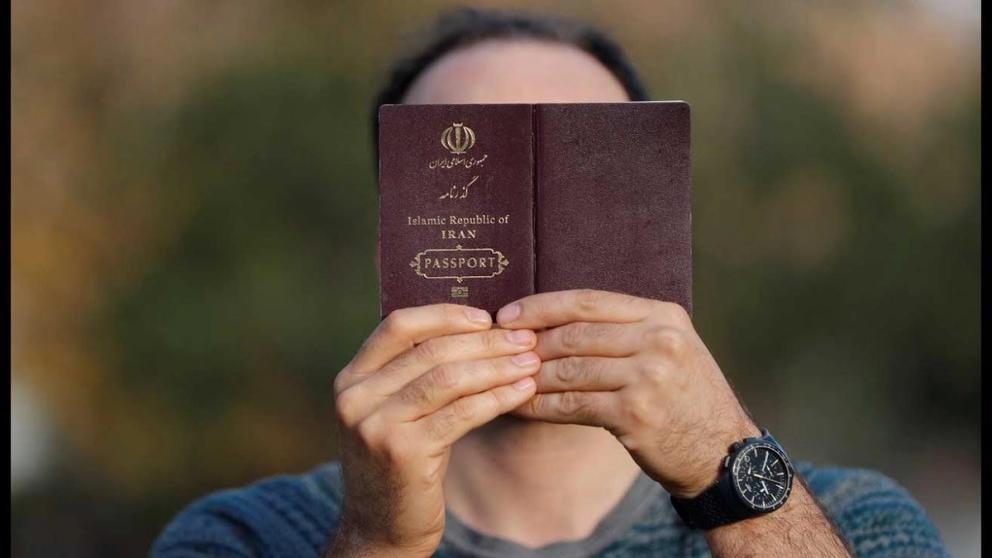 A man holding an Iranian passport  