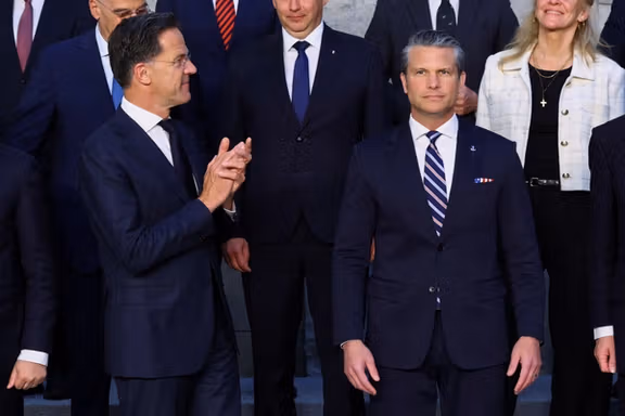 NATO Secretary General Mark Rutte gestures next to U.S. Defense Secretary Pete Hegseth, as they pose for a family photo during a meeting of NATO Defence Ministers at the alliance's headquarters in Brussels, Belgium, June 18, 2026.