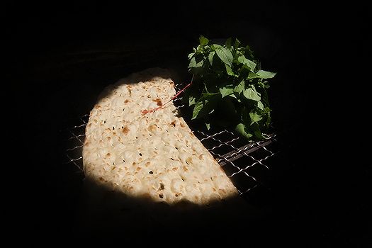 A traditional Iranian Sangak is left to cool down on a metal mesh table at a Tehran bakery (File photo)