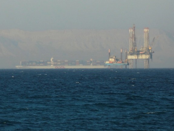 A container ship crosses an oil platform at the Gulf of Suez towards the Red Sea before entering the Suez Canal, outside of Cairo, Egypt September 1, 2020.